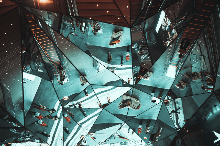 Reflection of crowd in glass pieces