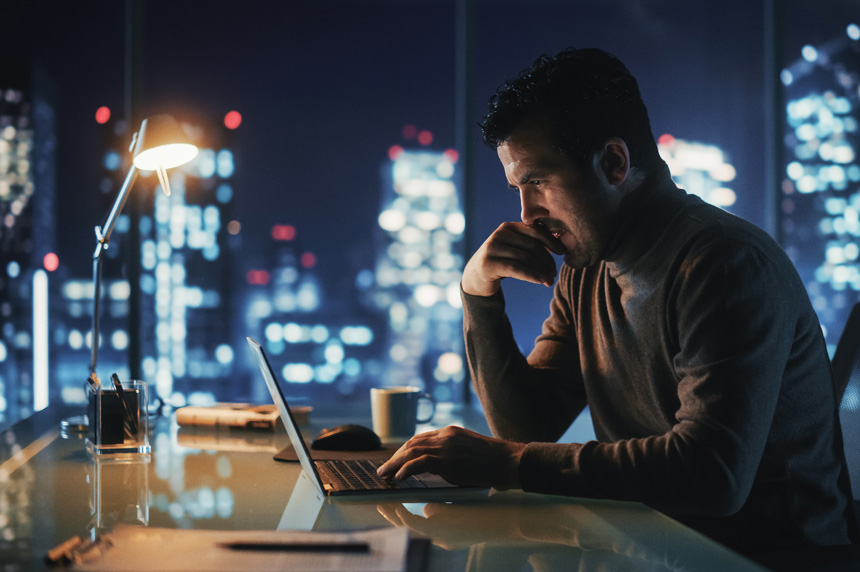 man at computer at night